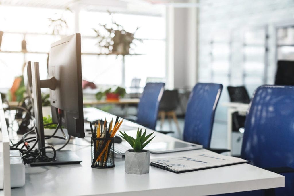 empty office with three blue chairs and a display