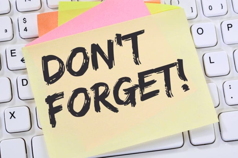 Sticky note with “Don’t Forget!” on a white keyboard as a reminder message