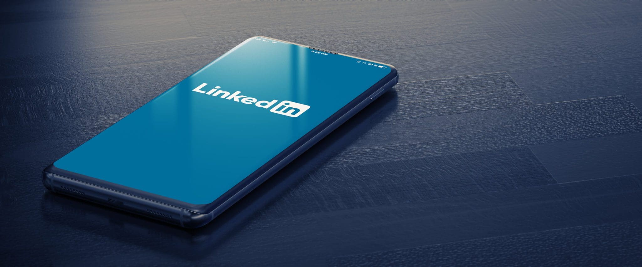 Smartphone displaying LinkedIn logo on screen, representing changes to the LinkedIn platform