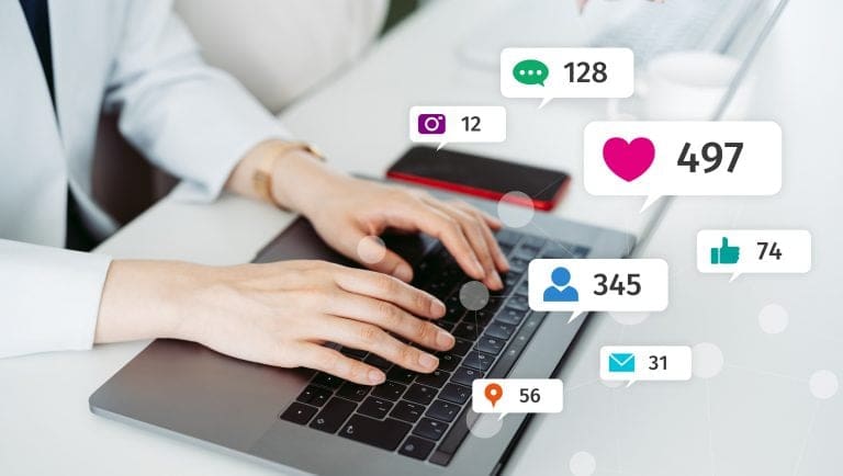 Person typing on laptop with social media notification icons for likes, comments, shares, and messages