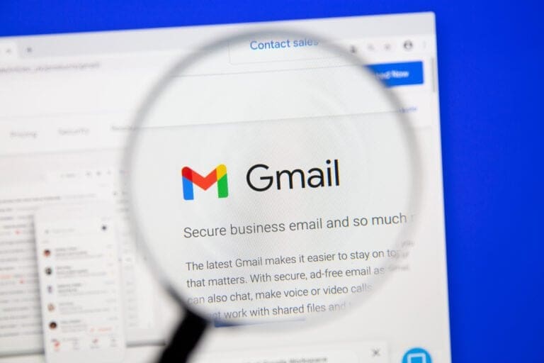 Magnifying glass highlighting Gmail branding on a webpage about secure business email