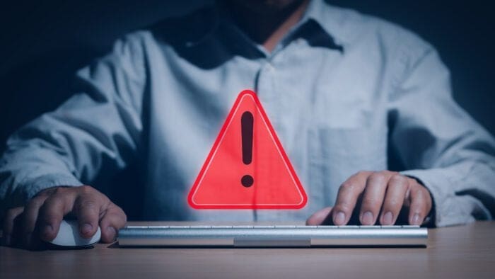 A person warning of a security threat with a red exclamation mark, representing the HTTP/2 rapid reset vulnerability in web technology.