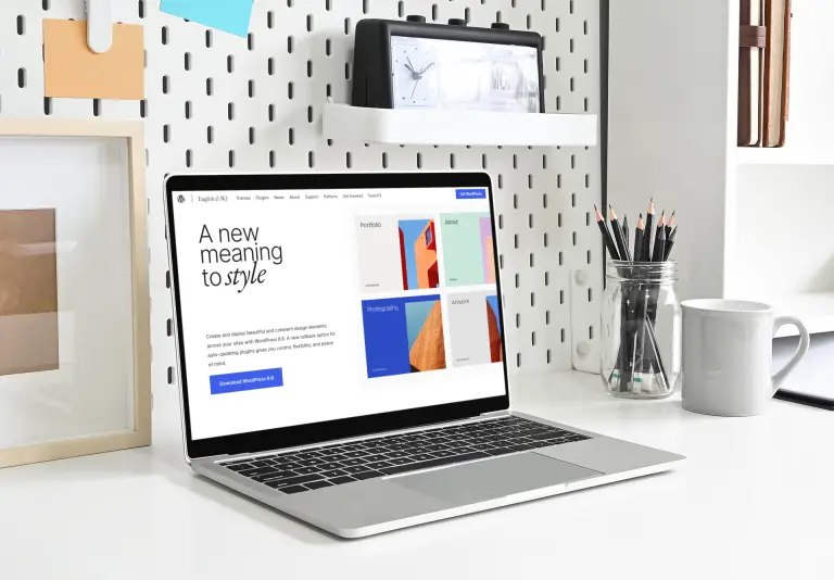 MacBook on a clean office desk representing modern web design and performance