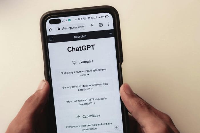 Person holding a smartphone with the ChatGPT interface open