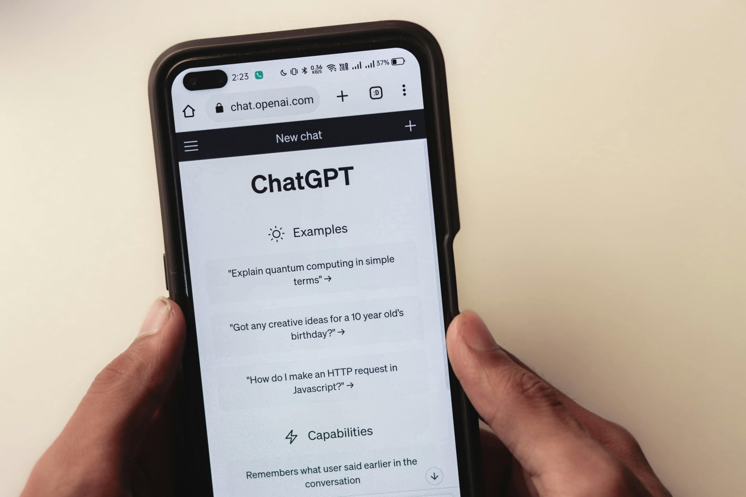 Person holding a smartphone with the ChatGPT interface open