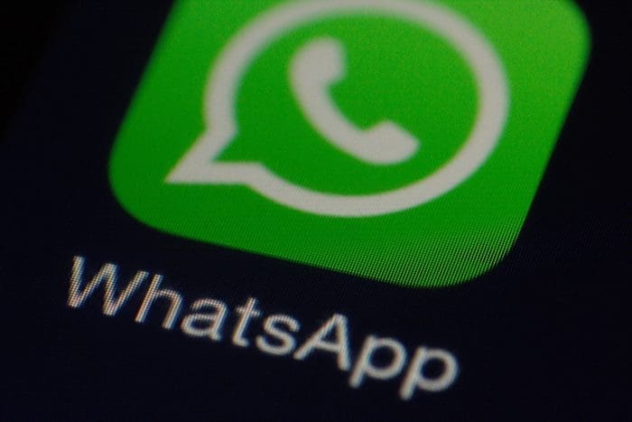 Smartphone screen displaying app icons with a focus on the green WhatsApp icon